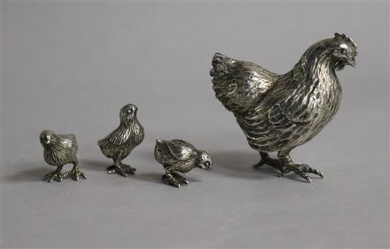 An Italian 800 standard white metal hen and three chicks.
